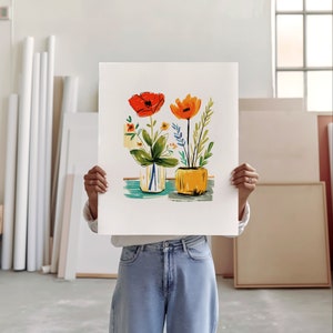 An artist studio room interior. A woman artist holds up a poster in front of her face. Concrete floor. Paper rolls and blank art canvas. Large warehouse windows, sunlight streams in