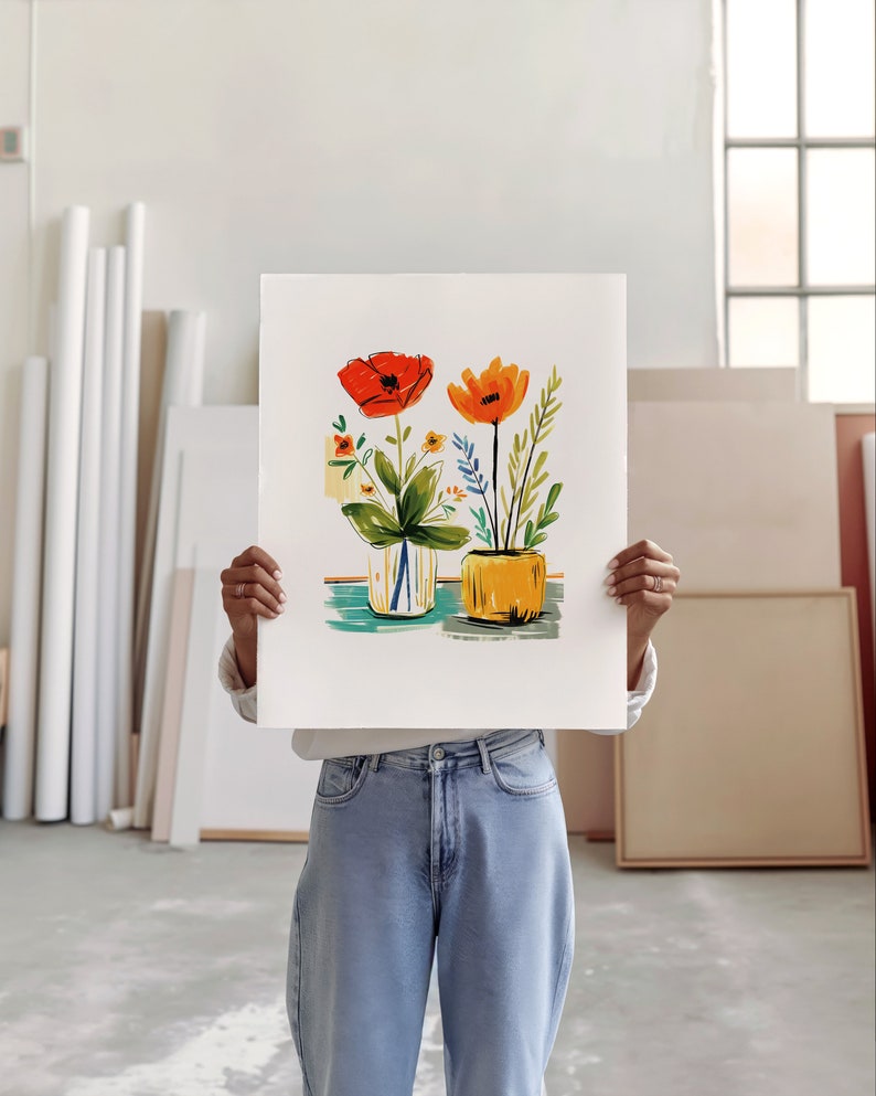 An artist studio room interior. A woman artist holds up a poster in front of her face. Concrete floor. Paper rolls and blank art canvas. Large warehouse windows, sunlight streams in