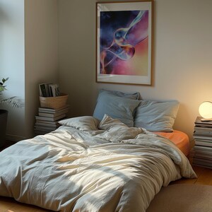 A dark moody bedroom with a floor bed. A large wood oak frame in on the wall above the bed.