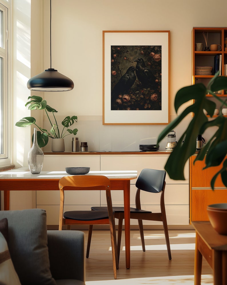 A cosy corner of a neutral wood kitchen with sunlight streaming in. A large framed artwork in on the wall