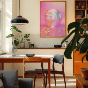 A cosy corner of a neutral wood kitchen with sunlight streaming in. A large framed artwork in on the wall