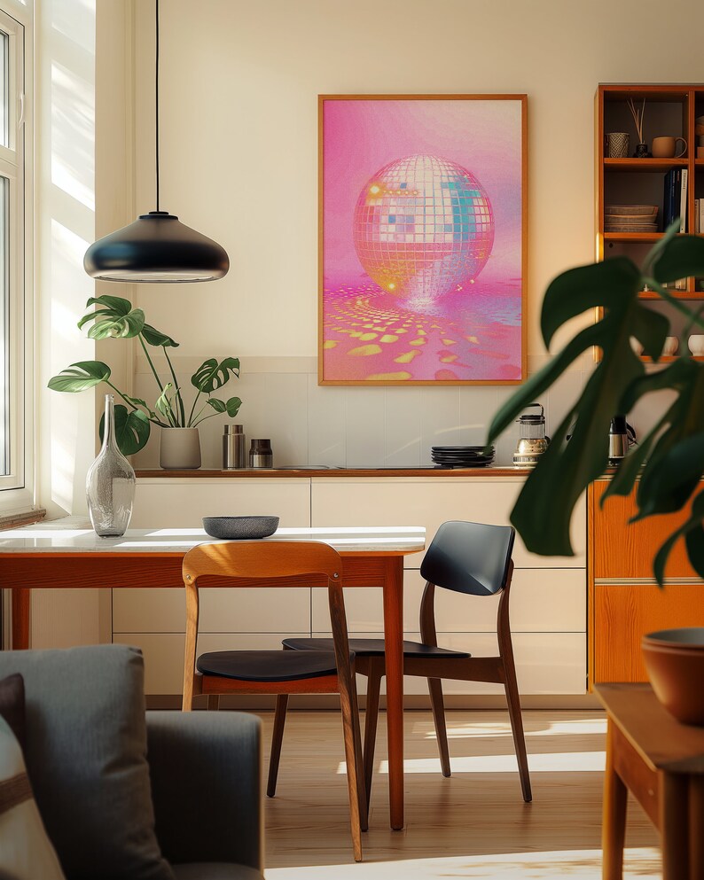 A cosy corner of a neutral wood kitchen with sunlight streaming in. A large framed artwork in on the wall