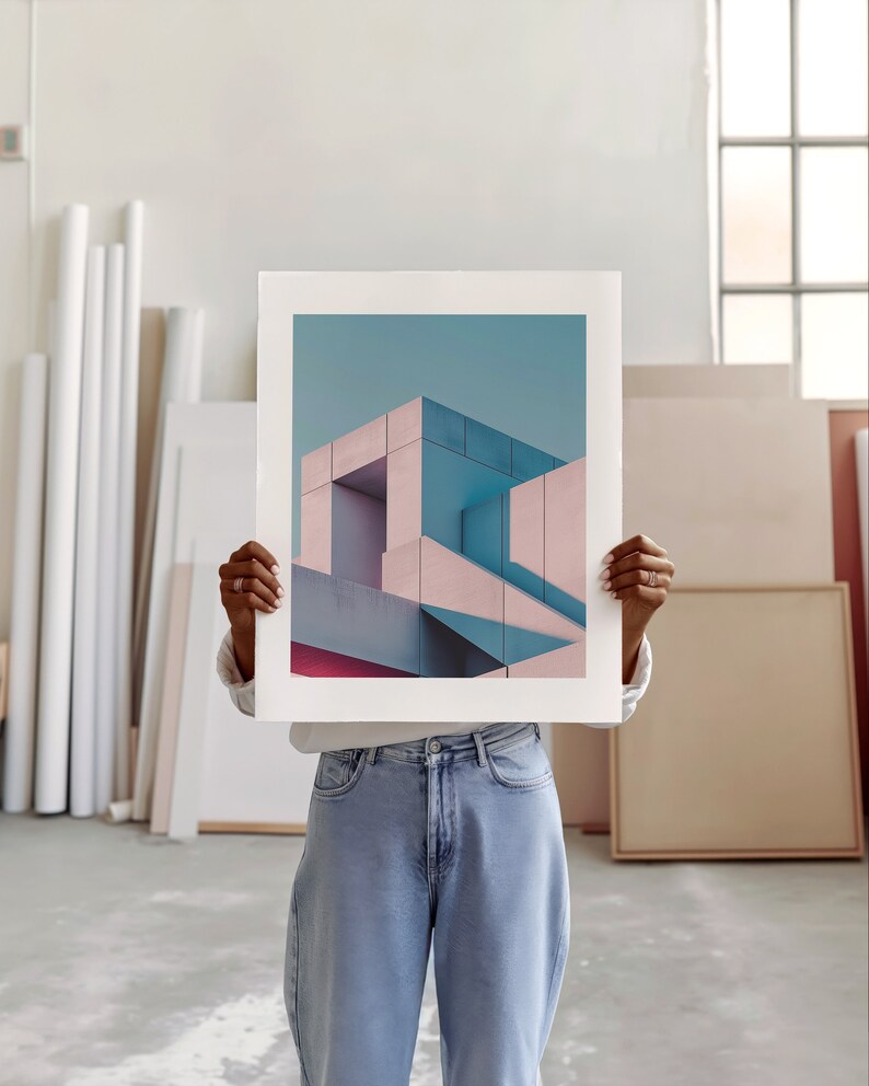 An artist studio room interior. A woman artist holds up a poster in front of her face. Concrete floor. Paper rolls and blank art canvas. Large warehouse windows, sunlight streams in