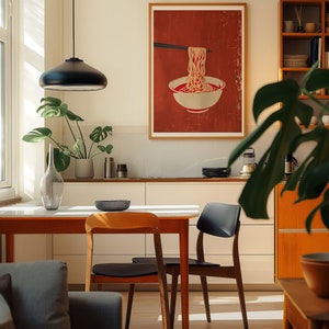 A cosy corner of a neutral wood kitchen with sunlight streaming in. A large framed artwork in on the wall