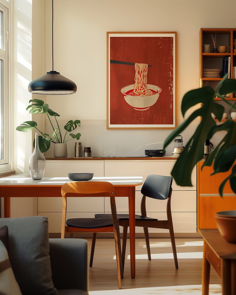 A cosy corner of a neutral wood kitchen with sunlight streaming in. A large framed artwork in on the wall