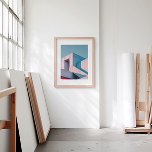 A blank thin oak wood frame mockup, in a minimal bright artist studio, with rolls of art paper and blank canvas