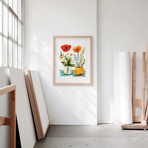 A blank thin oak wood frame mockup, in a minimal bright artist studio, with rolls of art paper and blank canvas