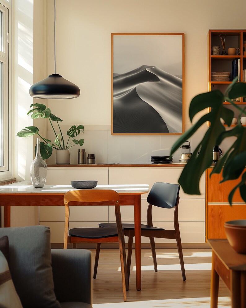 A cosy corner of a neutral wood kitchen with sunlight streaming in. A large framed artwork in on the wall