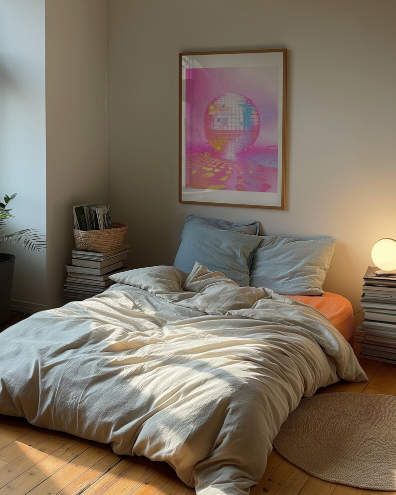 A dark moody bedroom with a floor bed. A large wood oak frame in on the wall above the bed.