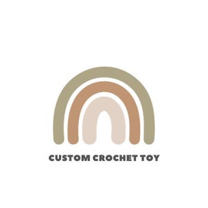May include: A logo featuring a stylized rainbow in muted earth tones: olive green, brown, and beige. The text "CUSTOM CROCHET TOY" is printed in a dark grey, sans-serif font below the rainbow graphic, set against a white background.