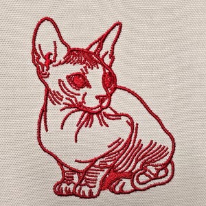 May include: Red embroidered image of a hairless cat sitting on a white background.
