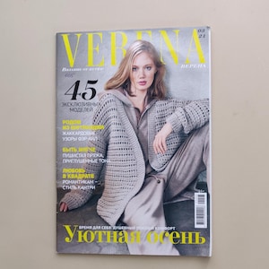 Op de afbeelding: Een editie 03/21 van het tijdschrift Verena met een persoon die een lichtgrijs open gebreid vest draagt over een bijpassende hoodie en broek. De cover bevat de tekst Verena, 45 эксклюзивных моделей en Уютная осень in het geel en wit.