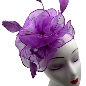 purple fascinator hat with headband and clip made of fabric with a burst of feathers for weddings, royal ascot, garden parties and races