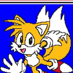 May include: A pixelated image of Tails from Sonic the Hedgehog, in shades of yellow, white, red, and blue. The text "Tails" and "Corner - To - Corner Crochet Pattern" are at the top. The character is smiling and waving.