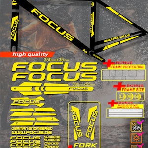 May include: A set of yellow and black bicycle frame stickers with the word "FOCUS" printed on them. The stickers are available in various sizes and include bonus frame protection, frame size, and reflective safety bars.