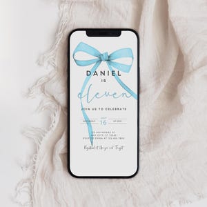 May include: A blue and white birthday invitation with a blue bow on the top. The invitation says "Daniel is eleven" and includes the date and time of the party. It also says "RSVP to Emma at 123.456.7890" and "Registered at Amazon and Target".