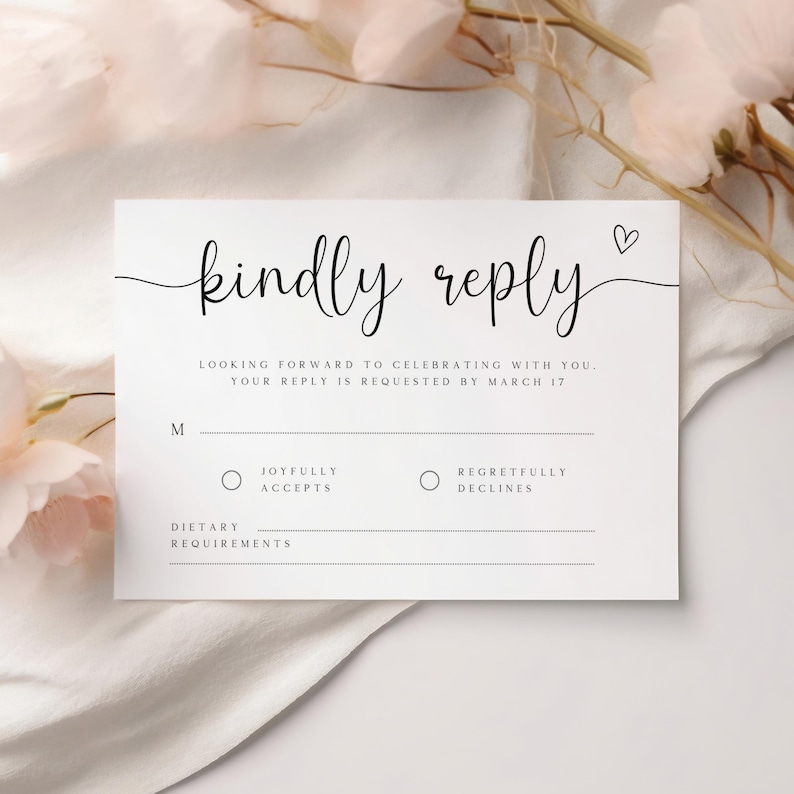 May include: A white RSVP card with black text that reads "kindly reply". The card includes a section for guests to indicate whether they will be attending the event, with options for "joyfully accepts" and "regretfully declines". There is also a space for dietary requirements.