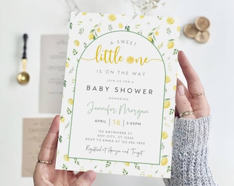 May include: A baby shower invitation with a lemon theme. The invitation features a yellow and green lemon pattern with the text "A Sweet Little One Is On The Way" and "Baby Shower". The invitation also includes the date, time, and location of the shower, as well as the name of the person being honored, Jennifer Morgan. The text "Registered at Amazon and Target" is also included.
