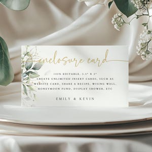 May include: A white enclosure card with a gold leafy design and the text "enclosure card" in gold script. The card also includes the text "100% EDITABLE, 3.5" X 2" CREATE UNLIMITED INSERT CARDS, SUCH AS WEBSITE CARD, SHARE A RECIPE, WISING WELL, HONEYMOON FUND, DISPLAY SHOWER, ETC EMILY & KEVIN".