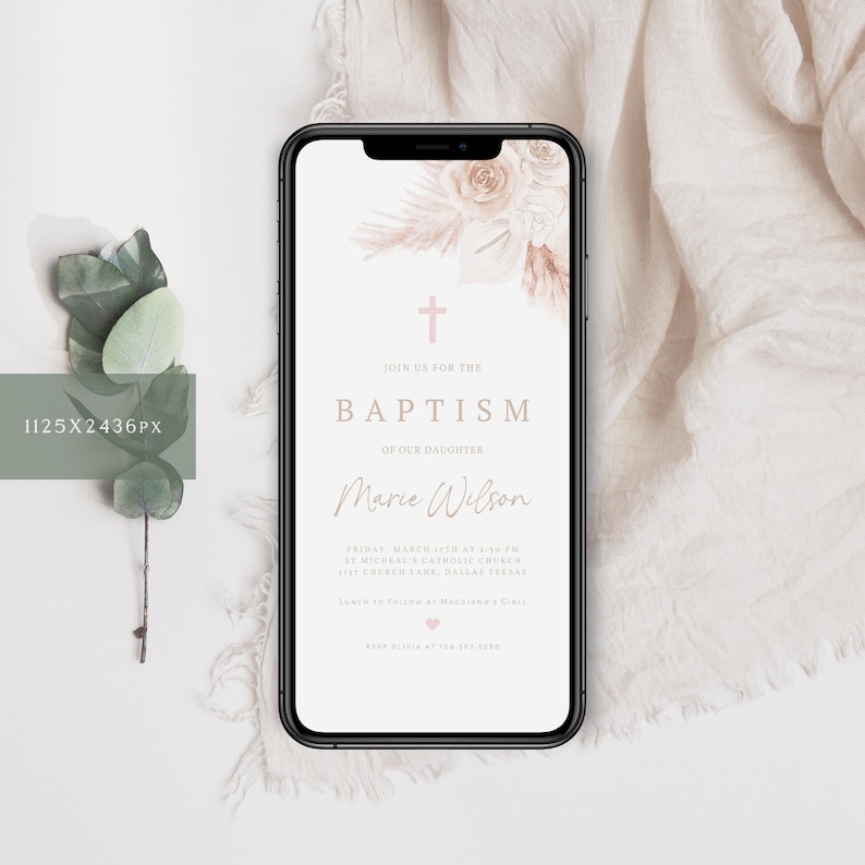 May include: A smartphone displays a digital baptism invitation. The design features a cross, floral accents, and the text "Join us for the Baptism of our Daughter, Marie Wilson." The color palette includes soft pinks and neutral tones.
