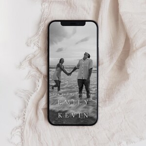 May include: Black and white photo of a couple holding hands on a beach. The text "For the wedding of Emily and Kevin" is at the bottom of the image.