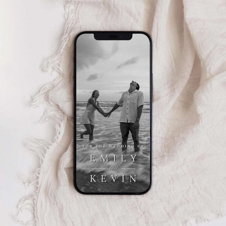 May include: Black and white photo of a couple holding hands on a beach. The text "For the wedding of Emily and Kevin" is at the bottom of the image.