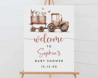May include: Welcome to Sophia's Baby Shower sign with a watercolor illustration of a red tractor pulling a wagon with farm animals. The sign is on an easel.