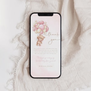 May include: A pink and white thank you card with a teddy bear holding balloons. The card says "thank you" and "The party is over, I'm officially one. Celebrating with you was so much fun. I loved the cake and presents too, but the very best part was seeing you. Thank you for making my First Birthday Sur special. With love, Evelyn."