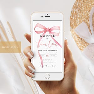 May include: A pink watercolor bow with the text "Sophie is twelve" on a white background. The text "Join us to celebrate" is below the bow. The date and time of the event are listed below the text. The text "RSVP to Emma at 123.454 7890" is at the bottom of the invitation.