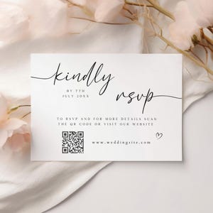 May include: White RSVP card with black text that reads "kindly RSVP by 7th July 20XX". The card also includes a QR code and the website address "www.weddingsite.com".