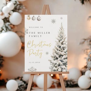 May include: A wooden easel displays a Christmas party welcome sign. The sign features a snow-covered Christmas tree illustration, snowflakes, and text that reads "Welcome to The Miller Family Christmas Party" in gold and black. The date 12.15.20XX is also included.