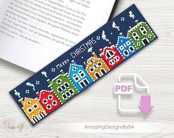 May include: A navy blue bookmark with a pixelated design of colorful houses and the text "MERRY CHRISTMAS." The houses are in shades of yellow, red, green, blue, and white. A PDF icon is in the lower right corner.