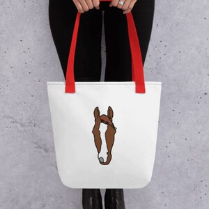 May include: White tote bag with red handles featuring a brown and white horse head illustration.
