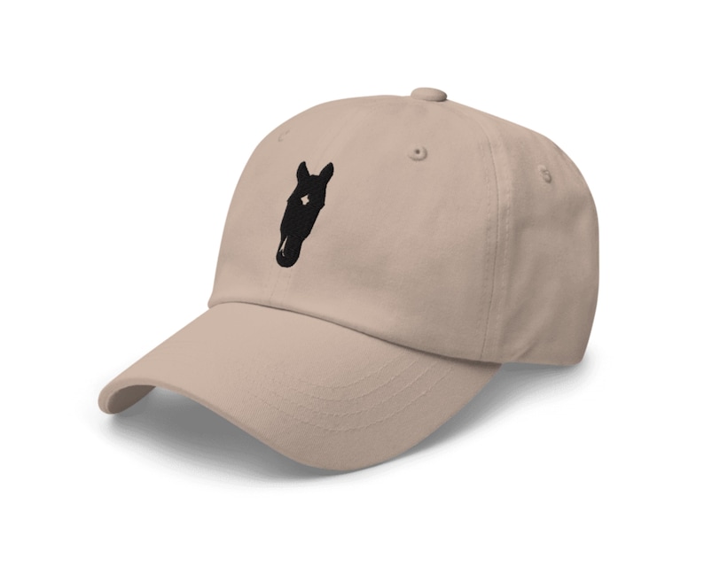 May include: A beige baseball cap with a black horse head silhouette embroidered on the front.
