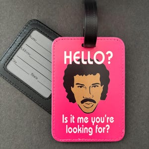 Luggage Tag (faux leather): "Hello? Is it me you’re looking for?" Lionel Richie bag tags - pink with white type. Removable info card!