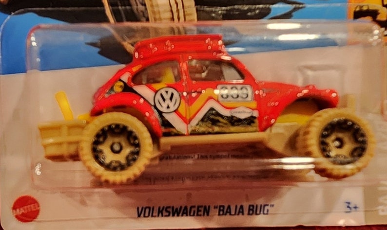 May include: A red Volkswagen Baja Bug toy car with a white and yellow racing stripe, a black VW logo, and the number "633" on the side. The car has a tan roof rack and tan off-road tyres.