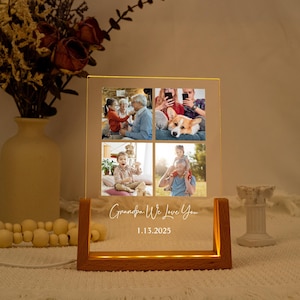 May include: A light-up photo display featuring four family photos. The wooden base emits a warm glow, with the text "Grandpa We Love You" and the date 1.13.2025 illuminated on the front.