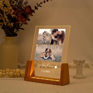 May include: A lighted acrylic photo display with three images of a couple. The display has a wooden base and the words "Love You Forever" and the date 1.13.2025 are etched on the front. The display is lit with a warm glow.