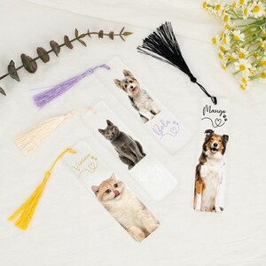 May include: Four white bookmarks with colorful tassels. Each bookmark features a different pet photo and name: Vivian, Bela, Mango, and Buddy. The bookmarks are perfect for dog and cat lovers.