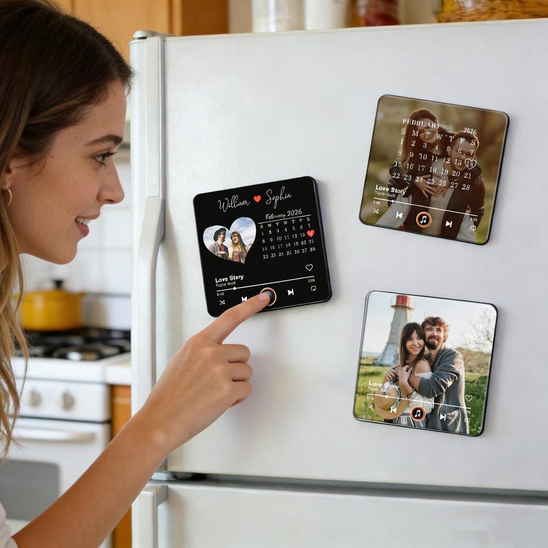 May include: Three square magnets with personalized photos and music player interfaces are displayed on a white fridge. The magnets feature images of couples, a calendar, and the text "Love Story". The magnets are black with white text.