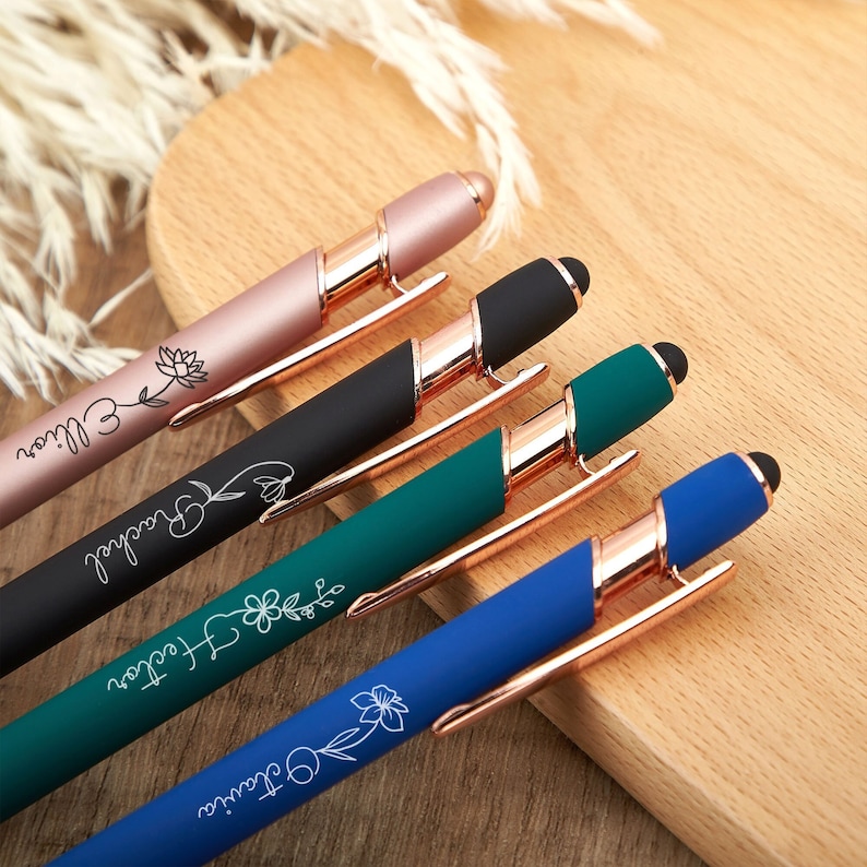 May include: Four personalized pens with rose gold accents and a stylus tip. The pens are black, blue, green, and pink with white floral designs and personalized text.