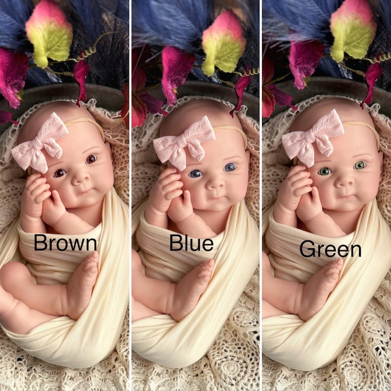 May include: Three images of a baby with brown, blue, and green eyes. Each baby wears a pink bow headband and is wrapped in a cream-coloured blanket. The text "Brown", "Blue", and "Green" is below each baby.