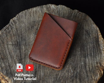 May include: A brown leather wallet with a folded flap. The wallet is on a wooden surface.  Pdf Pattern Video Tutorial.