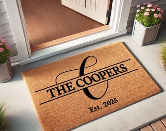 May include: A brown coir doormat with the text "The Coopers Est. 2025" and a stylized letter C.