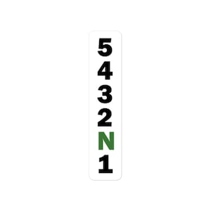 May include: A white sticker with black numbers 1 through 5 and the letter N in green, representing a gear shift pattern.