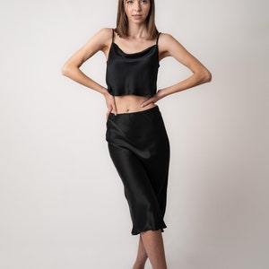 Woman wearing black crop camisole in pure silk with black silk skirt