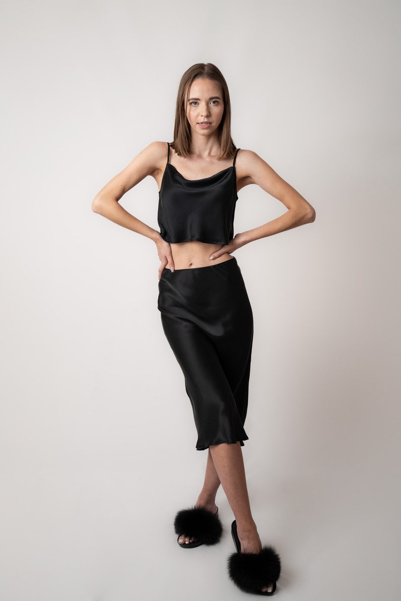 Woman wearing black crop camisole in pure silk with black silk skirt