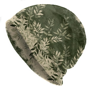 May include: A beanie hat with a botanical design. The hat features a dark green background with a pattern of light green and white leaves. The brim of the hat is a lighter shade of green. The hat is made of a soft, comfortable material.