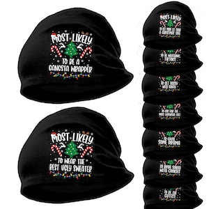 May include: Black beanie hats with Christmas-themed text. One hat reads "Most Likely To Be A Gangsta Wrapper." Another says "Most Likely To Wear The Best Ugly Sweater." Other hats have similar phrases.