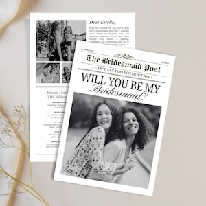 May include: A black and white newspaper-style invitation with the headline "The Bridesmaid Post" and the question "Will You Be My Bridesmaid?" Two women are smiling in a photo on the front. The invitation is on a cream-coloured surface.
